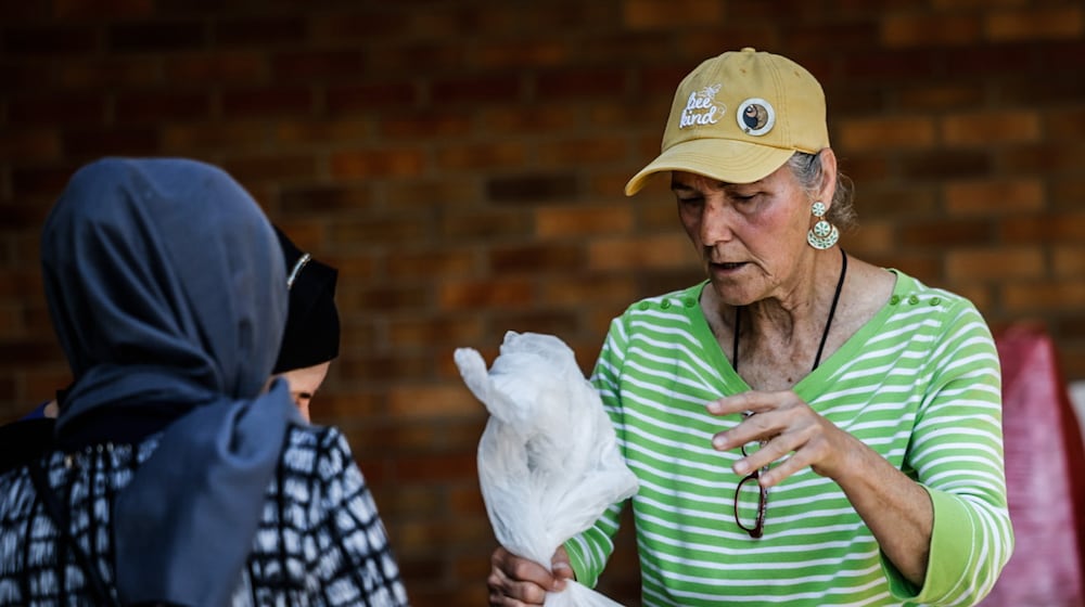 Community Gem Lucy Figner is a volunteer at Good Neighbor House food pantry on East First Street in Dayton. JIM NOELKER/STAFF