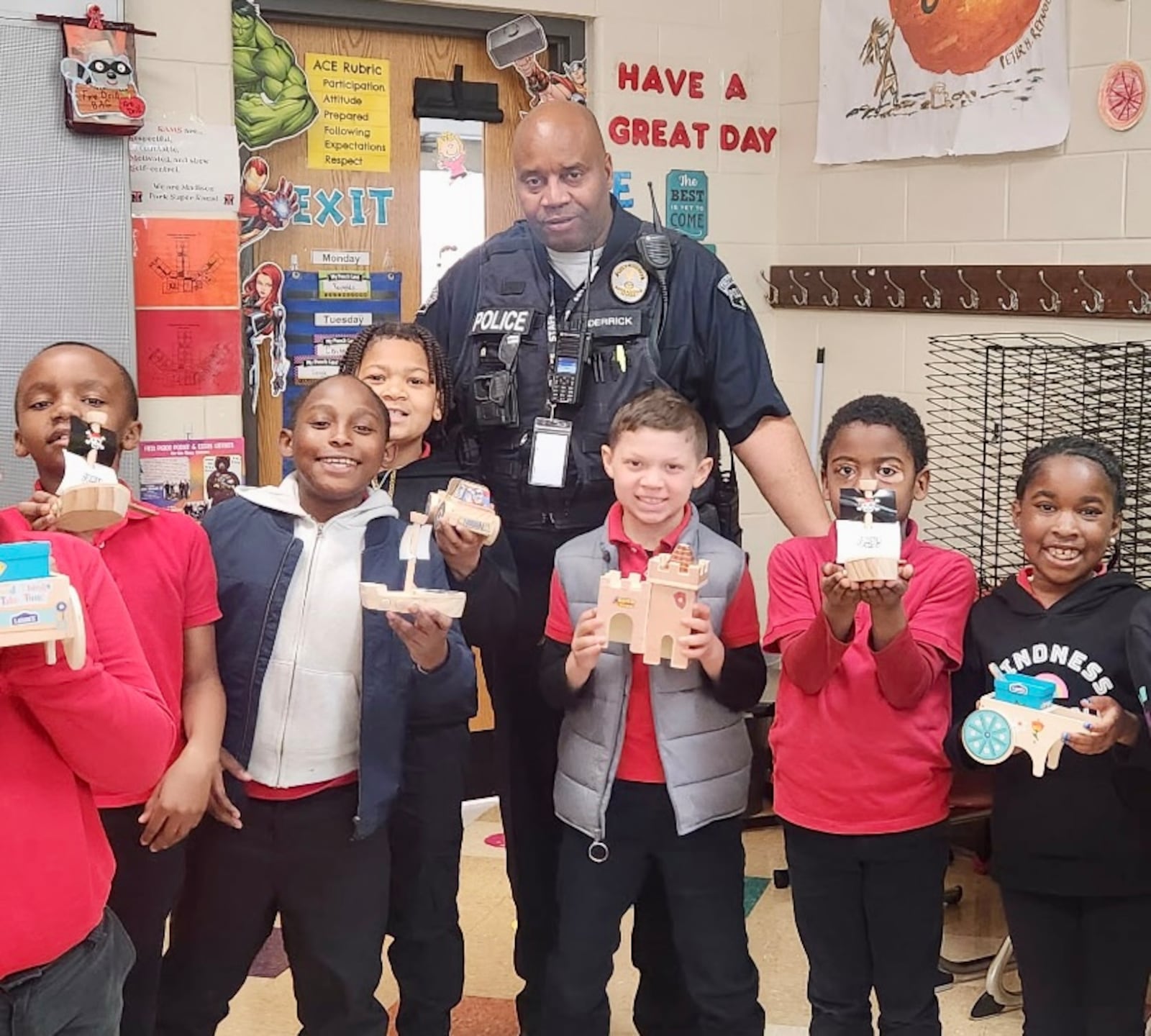 Officer Derrick with some of the kids he works with as a school resource officer for the Trotwood-Madison City School District. CONTRIBUTED