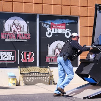 Investigators removed multiple machines from  Action Palace pool hall on Old Troy Pike in Huber Heights and loading them into a black van on Thursday, Sept. 11, 2025. BRYANT BILLING / STAFF