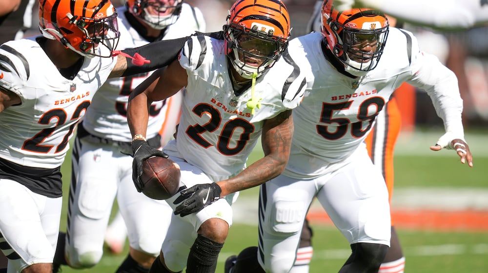 Cincinnati Bengals cornerback DJ Turner II (20) intercepts a pass during the second half of an NFL football game against the Cleveland Browns, Sunday, Sept. 7, 2025, in Cleveland. (AP Photo/Sue Ogrocki)