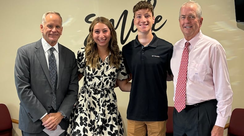 Dentist and Hundred Club of Miami County co-founder Dr. Thomas Grabeman (far right), along with co-founder Kevin Harlan (far left), pictured with siblings Mackenzie and Landon Misirian, the first two people to receive scholarships from the Hundred Club of Miami County in 2024. The group was founded in 2023. CONTRIBUTED