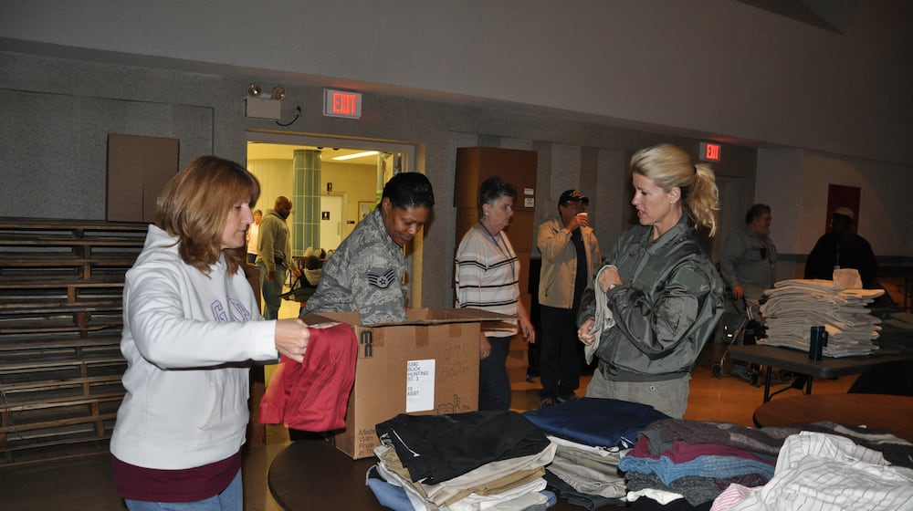 From left, Tech. Sgt. Eugenie Hinson, 445th Airlift Wing historian craftsman, Staff Sgt. Jawahna Hollins, 445th Airlift Wing executive assistant to the command chief, and Senior Master Sgt. Kelly Janus, 445th Aerospace Medicine Squadron medical services technician, unpack and sort through clothing for the 2012 Dayton Veteran’s Affairs Homeless Stand Down event. Air Force photo/Lt. Col. Cynthia Harris