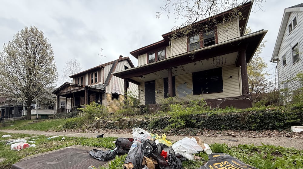 A couple of vacant homes on the first block of Pointview Avenue in Dayton's North Riverdale neighborhood. A teen was shot in a vacant home on this block last year during a drug deal. CORNELIUS FROLIK / STAFF