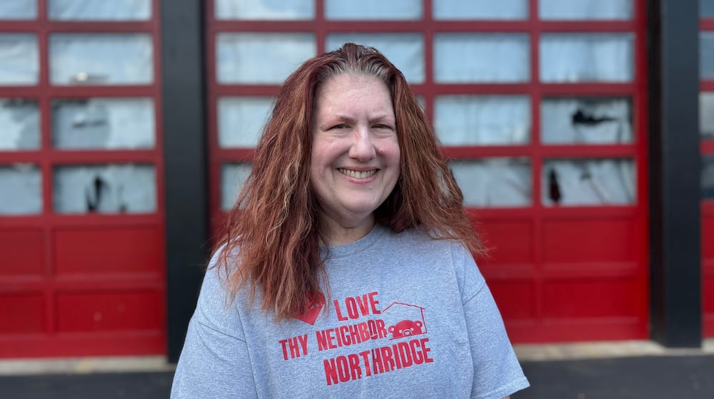 Nicole Lowe, co-founder of Polar Bear Book Swap in front of a Northridge fire station on July 14, 2025. Through a collaboration with Harrison Township, the nonprofit was given the space to use as a main headquarters to store, sort and organize books in. GRAETER / STAFF