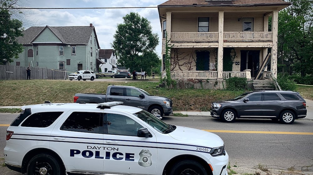 Homicide detectives at a crime scene after a male was found dead with a gunshot wound in the first block of West Helena Street in Dayton Wednesday, July 3, 2024. MARSHALL GORBY / STAFF