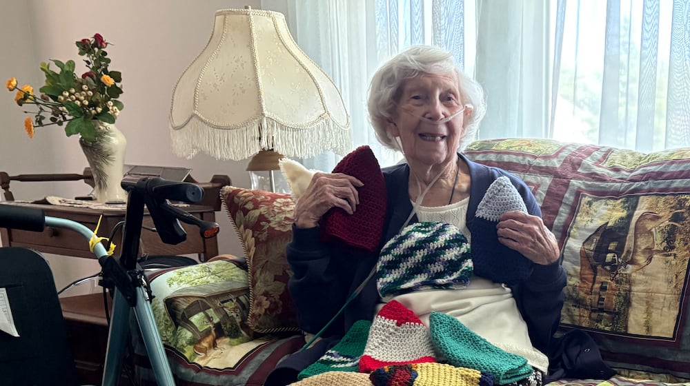 Kathy Moore at 100 crochets several dozen winter hats a year to donate to people in need. JEN BALDUF/STAFF