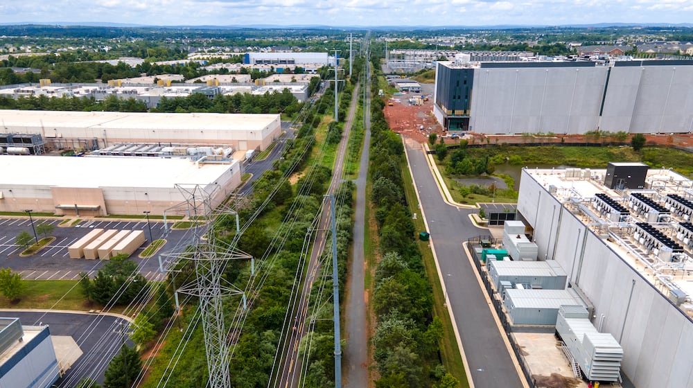FILE - High-voltage transmission lines provide electricity to data centers in Ashburn in Loudon County, Virginia, on Sunday, July 16, 2023.   (AP Photo/Ted Shaffrey, File)