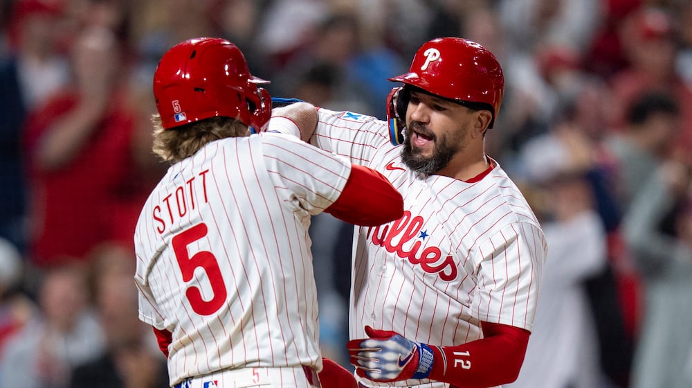 Philadelphia Phillies' Kyle Schwarber, right, reacts to his three-run home run with Bryson Stott, left, during the seventh inning of a baseball game against the New York Mets, Tuesday, Sep. 9, 2025, in Philadelphia. (AP Photo/Chris Szagola)