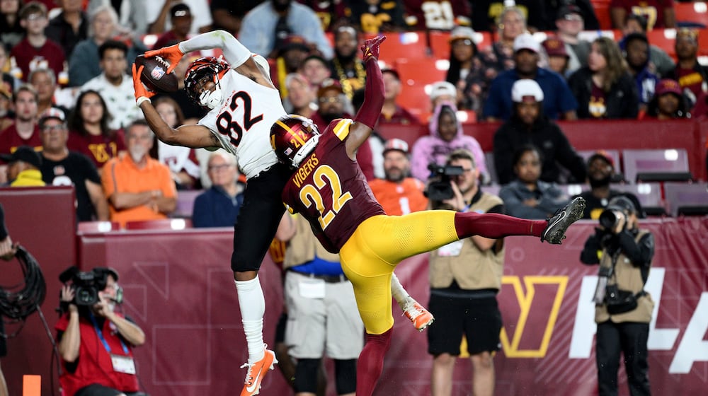 Cincinnati Bengals wide receiver Mitchell Tinsley (82) catches a touchdown pass as Washington Commanders cornerback Car'lin Vigers (22) defends during the first half of a preseason NFL football game Monday, Aug. 18, 2025, in Landover, Md. (AP Photo/Nick Wass)