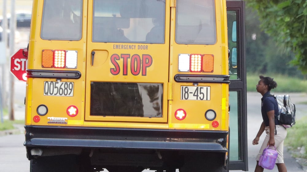 A child walks onto a Dayton Public Schools bus on Dearborn Avenue on Tuesday, Aug. 12. BRYANT BILLING / STAFF