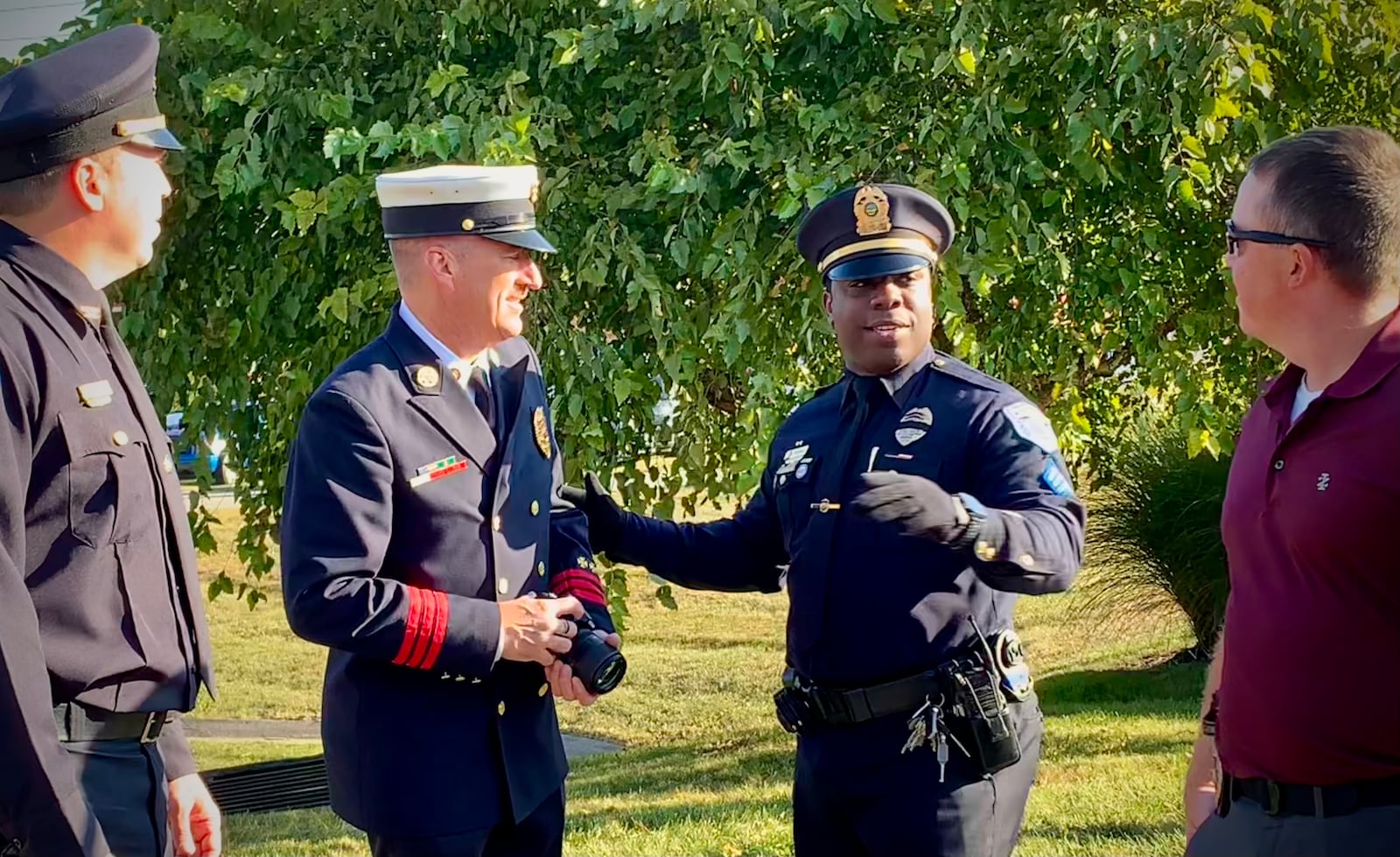 Beavercreek police officers and firefighters converse after the ceremony commemorating the events of 9/11, Thursday Sept. 11, 2025. LONDON BISHOP/STAFF