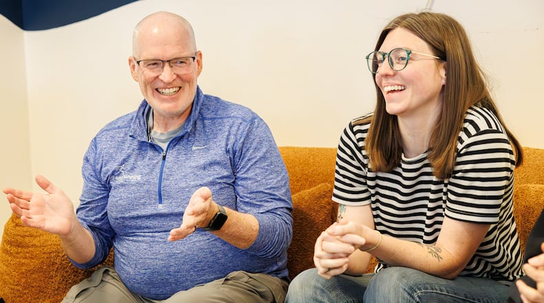 Brett Bogan (left) and Natalie Warrick (right) laugh during a group talk about sustainability at Val's Bakery in downtown Dayton on Friday, Aug. 29. Bogan and Warrick have been named Dayton Daily News Community Gems for their work with Waste-Free Dayton, which Warrick founded. BRYANT BILLING / STAFF