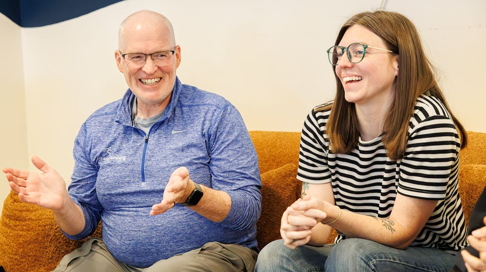 Brett Bogan (left) and Natalie Warrick (right) laugh during a group talk about sustainability at Val's Bakery in downtown Dayton on Friday, Aug. 29. Bogan and Warrick have been named Dayton Daily News Community Gems for their work with Waste-Free Dayton, which Warrick founded. BRYANT BILLING / STAFF