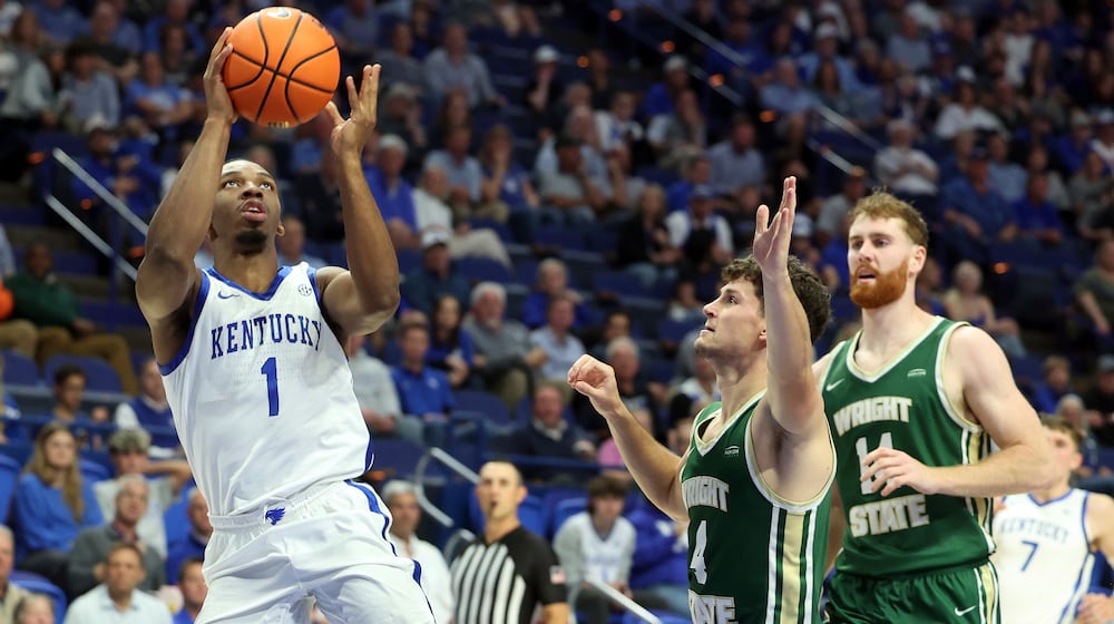 Kentucky's Lamont Butler (1) takes an off balance shot near Wright State's Keaton Norris, middle and Brandon Noel, right, during the second half of an NCAA college basketball game in Lexington, Ky., Monday, Nov. 4, 2024. Kentucky won 103-62. (AP Photo/James Crisp)