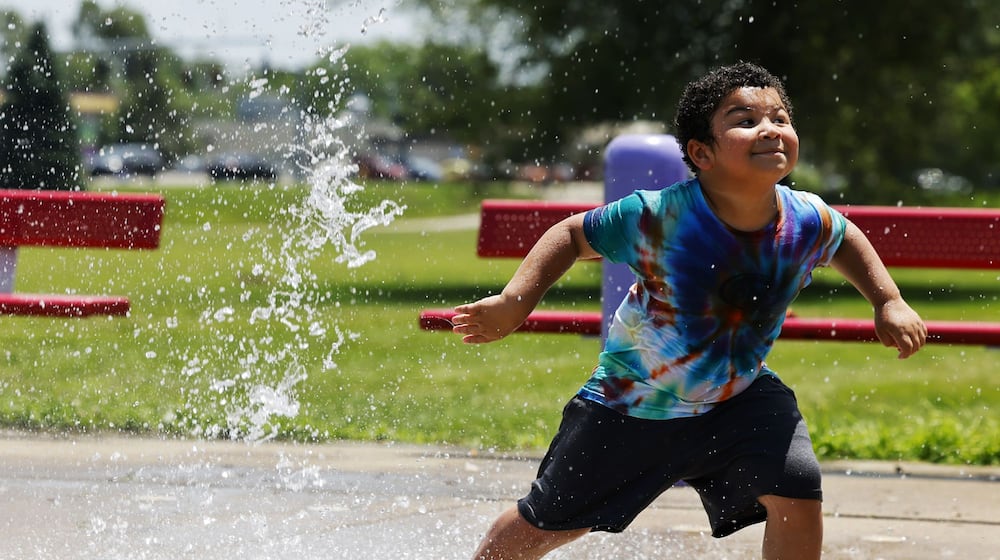 Sonny Gibson, 7. cools off in the splash pad at Douglass Park Monday, June 23, 2025 in Middletown. NICK GRAHAM/STAFF