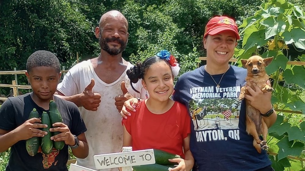 DeVann Carter with garden club youth, RJ, left, Keiarra May, right, and Mary McDermott, far right, holding Choo Choo the garden dog in 2025. CONTRIBUTED