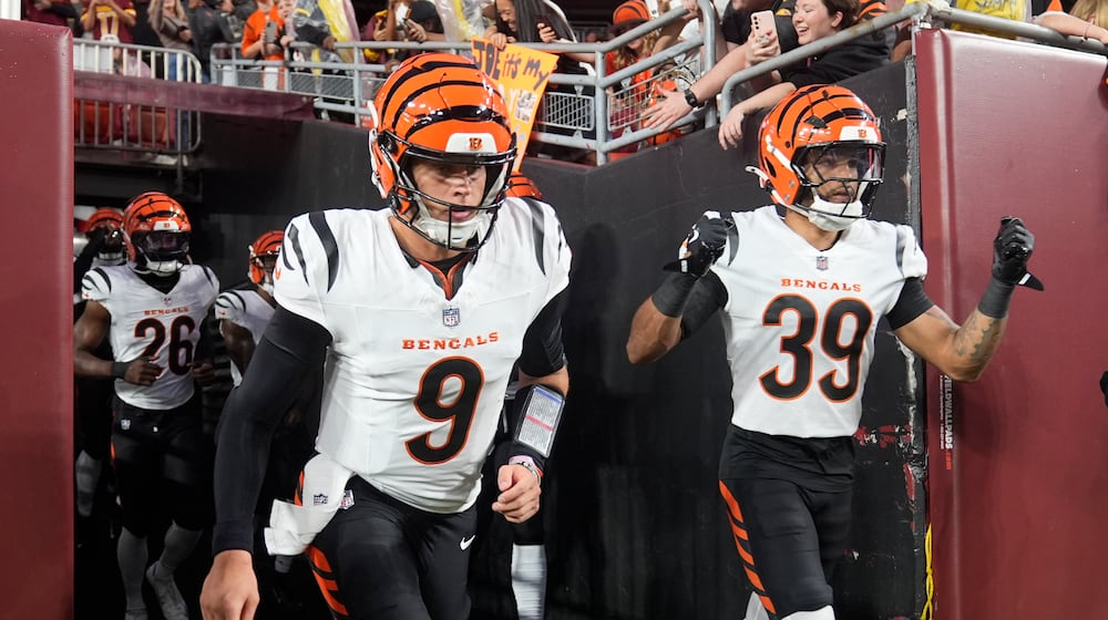 Cincinnati Bengals quarterback Joe Burrow (9) and cornerback Lance Robinson (39) jog out of the tunnel before a preseason NFL football game against the Washington Commanders Monday, Aug. 18, 2025, in Landover, Md. (AP Photo/Stephanie Scarbrough)