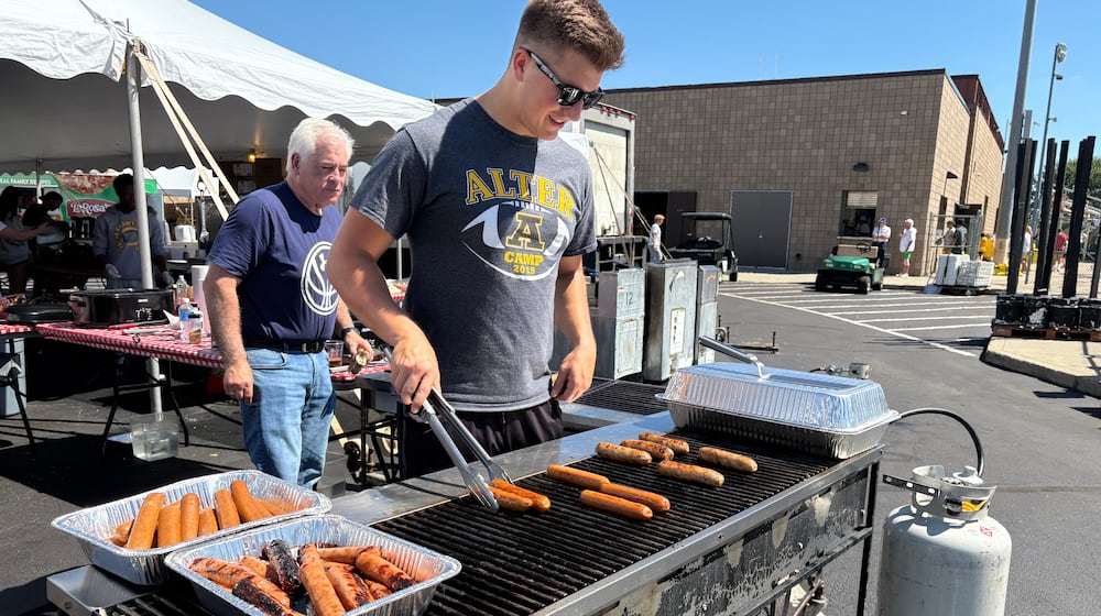 Alter High School alumnus and AlterFest volunteer Joe Manfre is grilling hotdogs, brats and burgers Saturday, Aug. 30, 2025, in Kettering. jEN BALDUF/STAFF