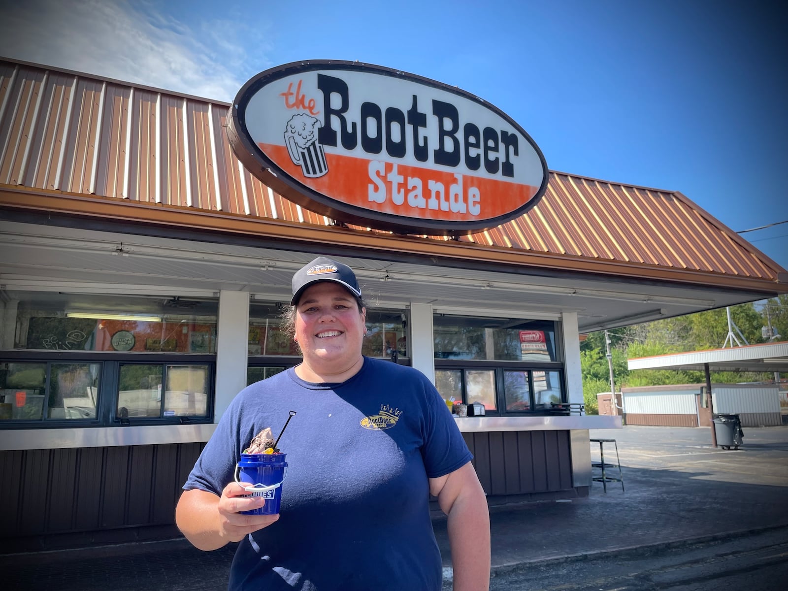 The Root Beer Stande, located at 1727 Woodman Drive in Dayton, is offering a dirt sundae special that is served in a Menards or Lowe's mini bucket with a shovel spoon. Pictured is owner Emily Collins. NATALIE JONES/STAFF