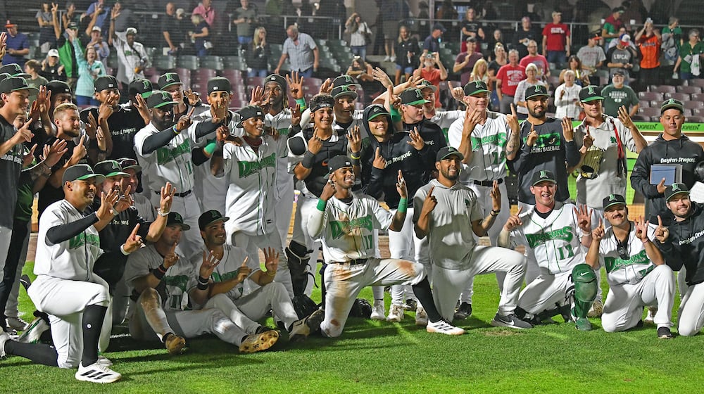 The Dragons signal 1-4 to celebrate their club record 14-game winning streak Tuesday night at Day Air Ballpark after rallying in the eighth inning to defeat Lansing 4-3. JEFF GILBERT/CONTRIBUTED