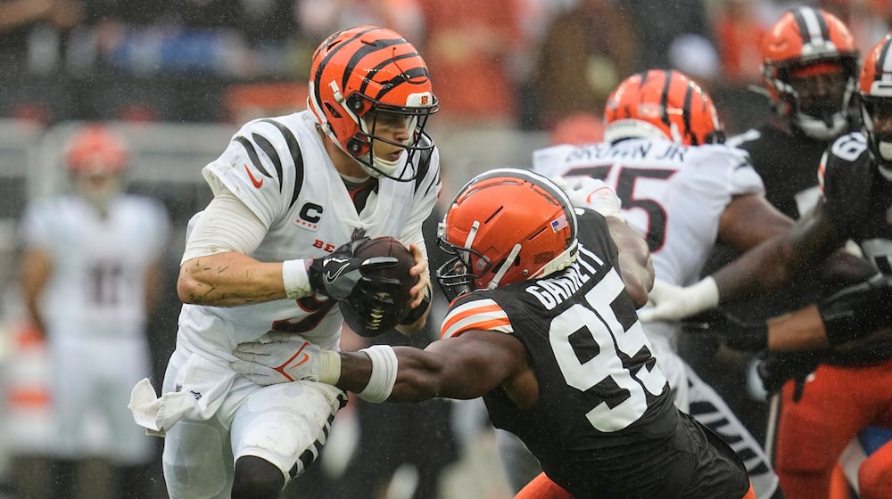FILE - Cincinnati Bengals quarterback Joe Burrow (9) is pressured by Cleveland Browns defensive end Myles Garrett (95) during an NFL football game Sept. 10, 2023, in Cleveland. (AP Photo/Sue Ogrocki, File)