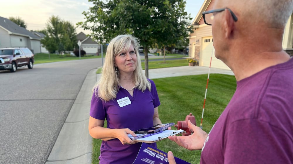 Republican candidate Ruth Bittner, who is running for the House District 34B seat, speaks with a potential voter while knocking on doors in Brooklyn Park, Minn., Thursday, Aug. 28, 2025. (Nathaniel Minor/Star Tribune via AP)