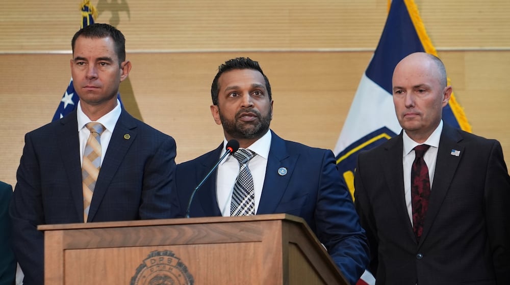 Kash Patel speaks at a news conference, Friday, Sept. 12, 2025, in Orem, Utah, as Utah department of public safety commissioner Beau Mason, left, and Utah Gov. Spencer Cox listen. (AP Photo/Lindsey Wasson)