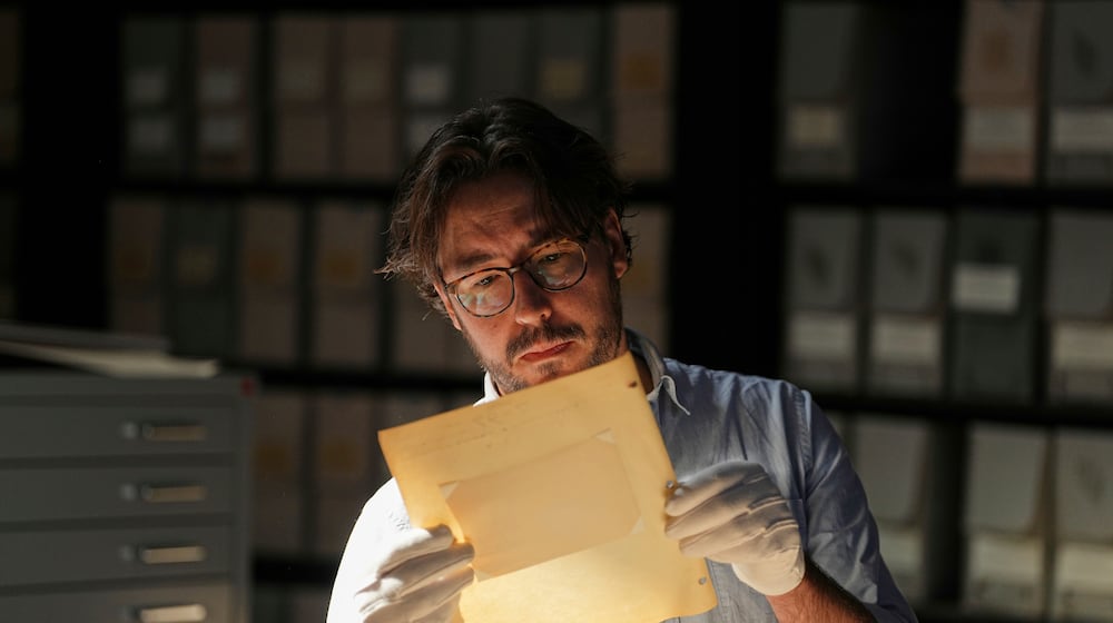University of Victoria postdoctoral fellow Nathaniel Brunt views an image from a collection of photos of the Yazidi people in their northern Iraq homeland in the 1930s, during an interview at the Penn Museum Archives in Philadelphia, Aug. 27, 2025. (AP Photo/Matt Rourke)