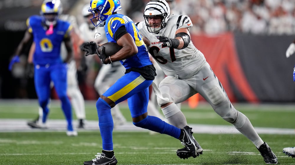 Los Angeles Rams defensive back Ahkello Witherspoon (44) runs with the ball after intercepting a pass as Cincinnati Bengals guard Cordell Volson (67) defends during the second half of an NFL football game Monday, Sept. 25, 2023, in Cincinnati. (AP Photo/Michael Conroy)