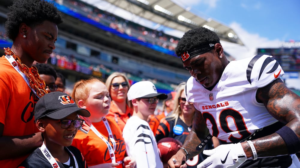 Cincinnati Bengals' Cam Taylor-Britt signs an autograph before a preseason NFL football game against the Indianapolis Colts, Saturday, Aug. 23, 2025, in Cincinnati. (AP Photo/Jeff Dean)