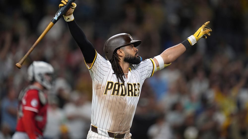 San Diego Padres' Fernando Tatis Jr. celebrates after hitting a game-winning sacrifice fly during the tenth inning of a baseball game against the Cincinnati Reds Monday, Sept. 8, 2025, in San Diego. San Diego Padres' Jake Cronenworth scored from third base on the play, and the Padres won 4-3. (AP Photo/Gregory Bull)