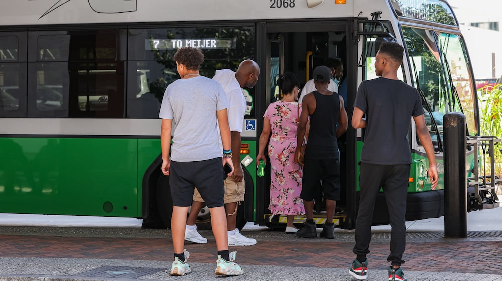 Passengers enter a Greater Dayton RTA bus at Wright Stop Plaza Transit Center on Friday, June 27. Dayton Public Schools has started giving RTA bus passes to students after a court in Franklin County issued a temporary restraining order on a state law preventing DPS students from transferring at the RTA hub with school-purchased passes. BRYANT BILLING / STAFF