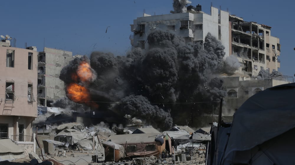 Smoke and flames rise after an Israeli military strike on a building in Gaza City, Friday, Sept. 12, 2025. (AP Photo/Yousef Al Zanoun)