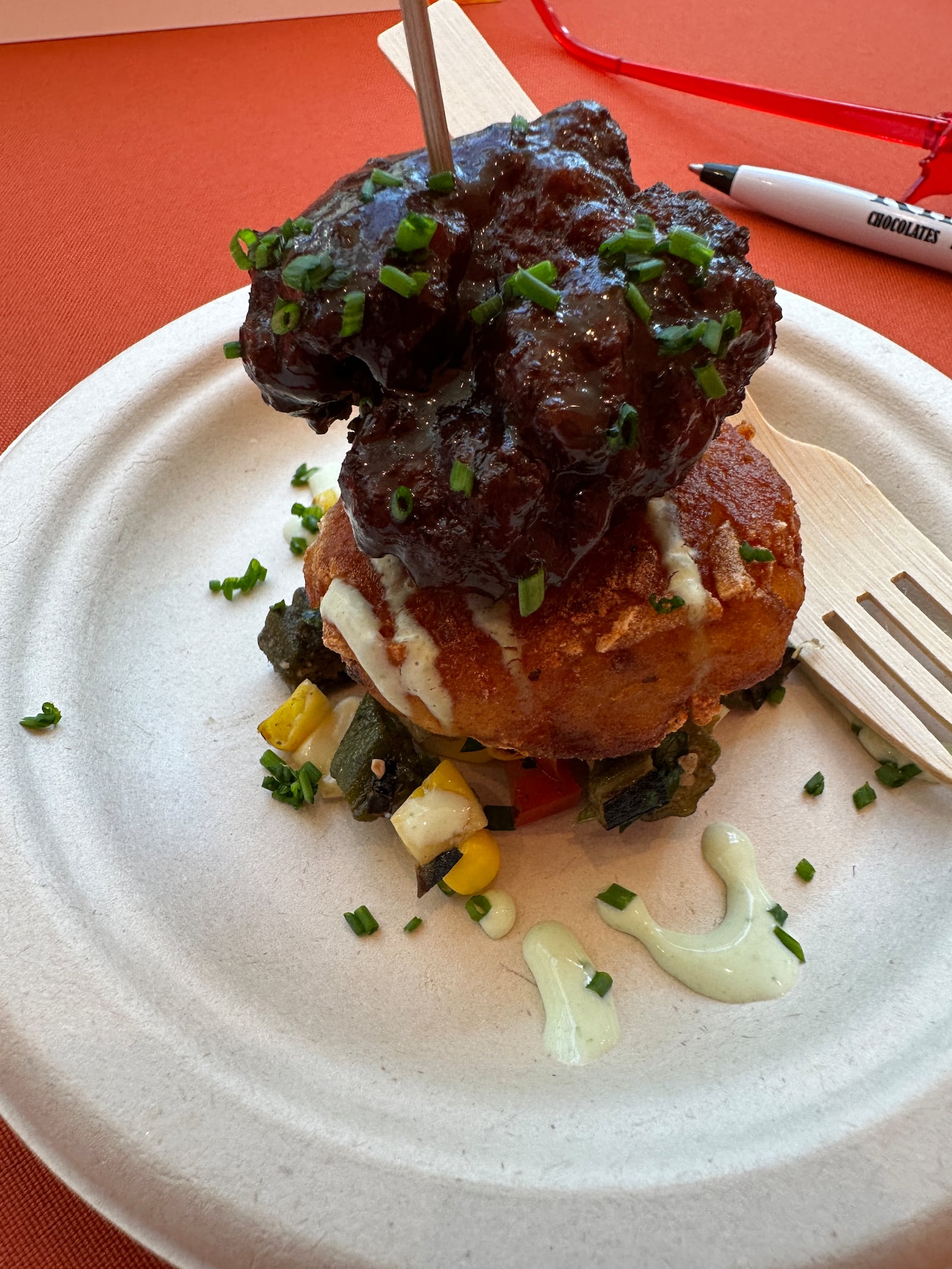 Jacob Rodibaugh from Bistecca served fire roasted okra and corn relish with Rösti potatoes and chive yogurt sauce. He turned the breakfast sausage into Italian sausage and made a sweet and spicy glaze for the meatball (MIAMI VALLEY MEALS)
