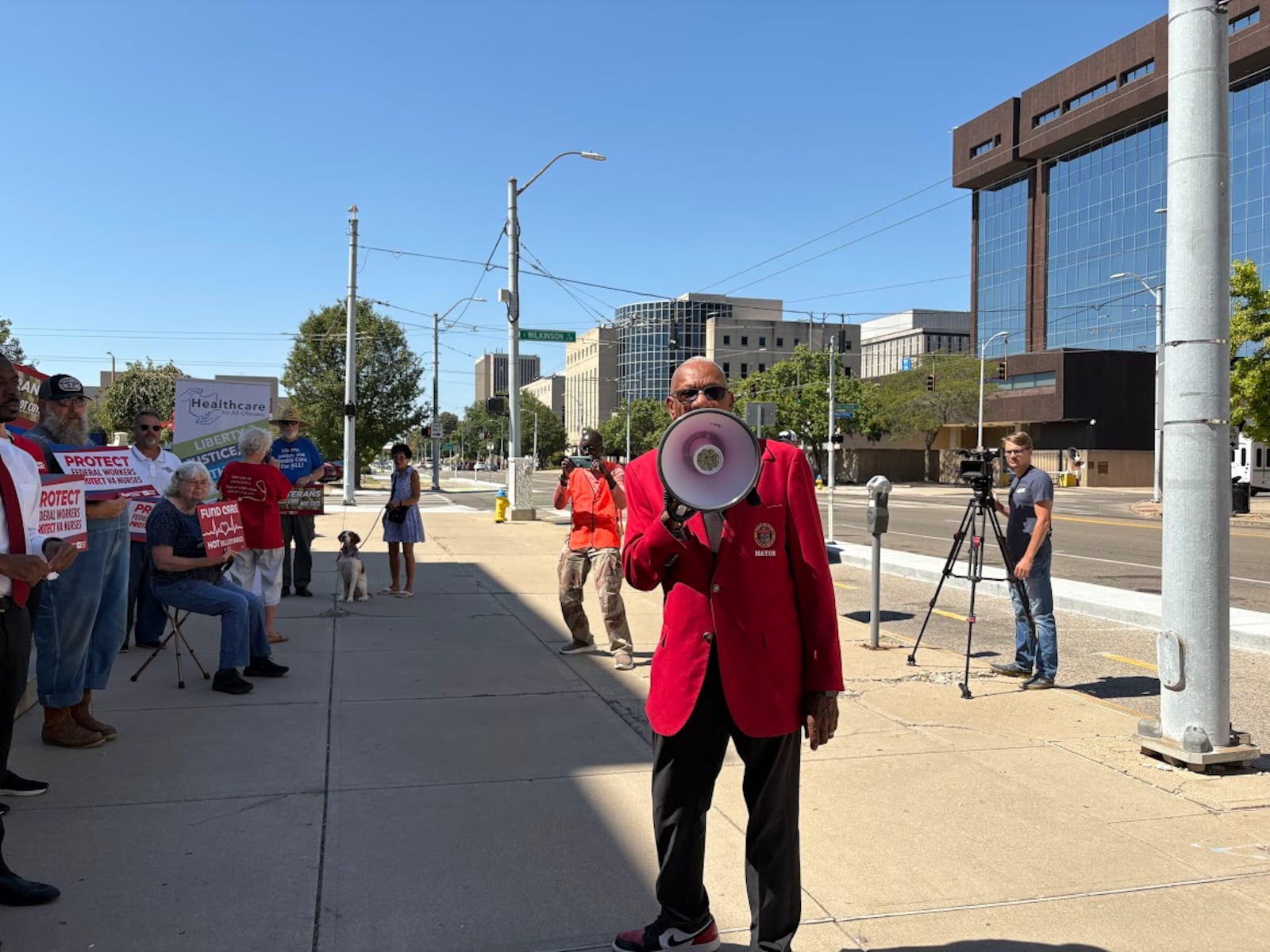 Dayton Mayor Jeffrey Mims Jr. makes his case with a bullhorn Friday Sept. 12, 2025 in a rally to protect VA jobs in downtown Dayton. THOMAS GNAU/STAFF
