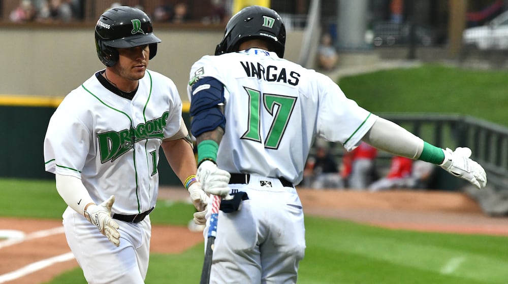 Dayton's John Michael Faile is greeted by Alexander Vargas after hitting a solo homer during their game on Wednesday, Aug. 20 at Day Air Ballpark. JEFF GILBERT/CONTRIBUTED