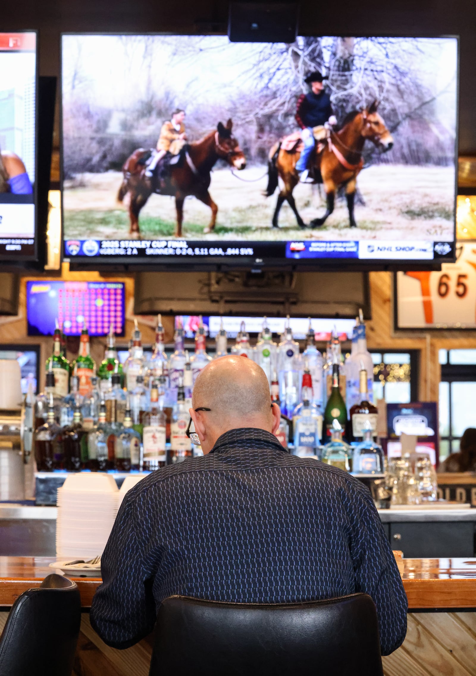 A man sits at the bar at Roosters in Beavercreek. BRYANT BILLING / STAFF