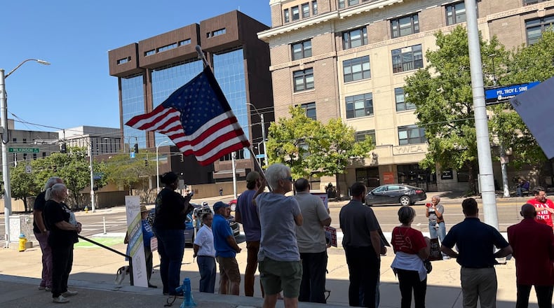 A group rallied Friday Sept. 12, 2025 outside a downtown Dayton federal offices building, urging U.S. Rep. Mike Turner to protect VA jobs. Two members of the group met with Turner staff members. THOMAS GNAU/STAFF
