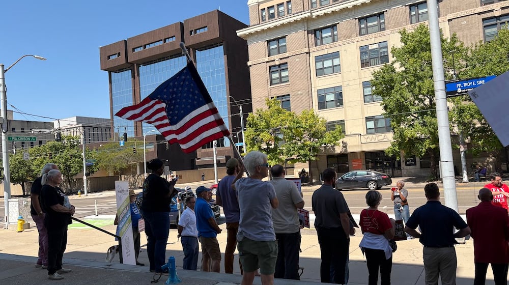 A group rallied Friday Sept. 12, 2025 outside a downtown Dayton federal offices building, urging U.S. Rep. Mike Turner to protect VA jobs. Two members of the group met with Turner staff members. THOMAS GNAU/STAFF