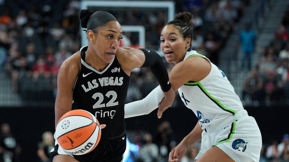 Las Vegas Aces center A'ja Wilson (22) drives around Minnesota Lynx forward Napheesa Collier (24) during the first half of a WNBA basketball game Thursday, Sept. 4, 2025, in Las Vegas. (AP Photo/John Locher)