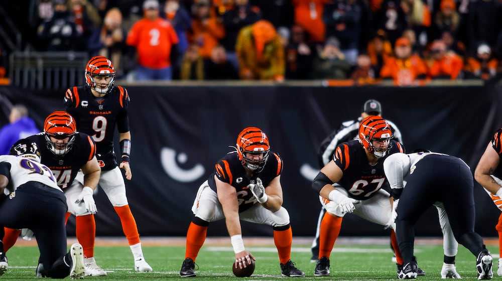 Bengals center Ted Karras hikes the ball to quarterback Joe Burrow during Cincinnati's AFC Wild Card playoff game against the Baltimore Ravens Sunday, Jan. 15, 2023 at Paycor Stadium in Cincinnati. The Bengals won 24-17. NICK GRAHAM/STAFF