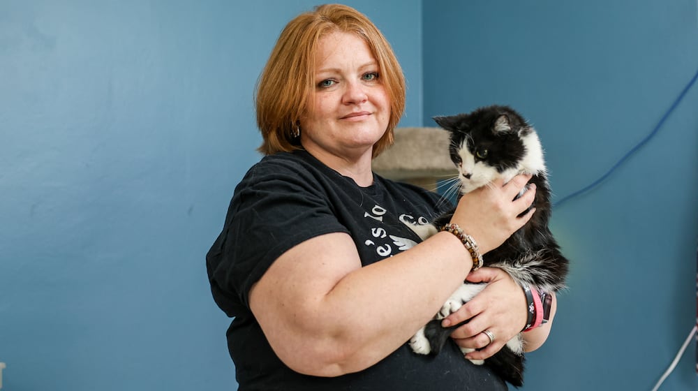 Melia Rambo-Stump has been named a Dayton Daily News Community Gem for founding Blue's Haven Cat Rescue. She is holding Wrigley, a cat that was rescued near Wrigley Field in Chicago. BRYANT BILLING / STAFF