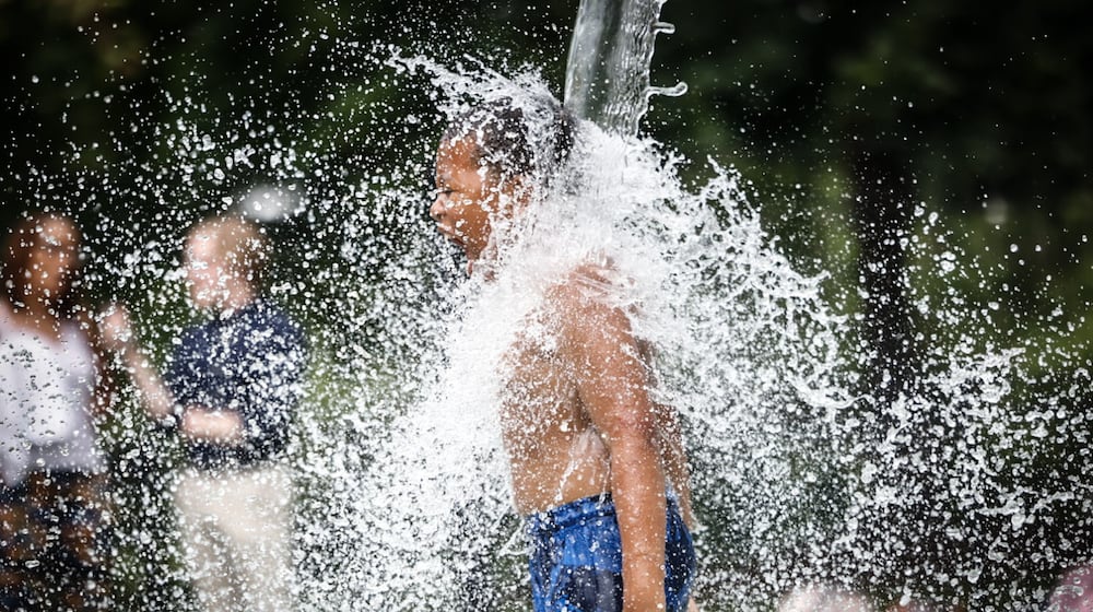 Kids and adults enjoyed the splash pad at Island MetroPark Tuesday June 18, 2024. This week the Dayton area is expecting near100 degree temperatures all week. JIM NOELKER/STAFF