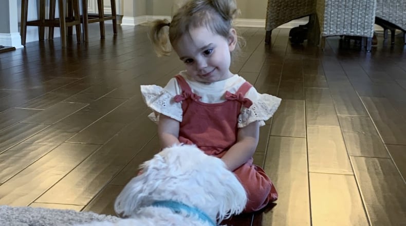 Harry the dog is seen with 2 year-old Madelyn, granddaughter of of Sue Cruse. CONTRIBUTED