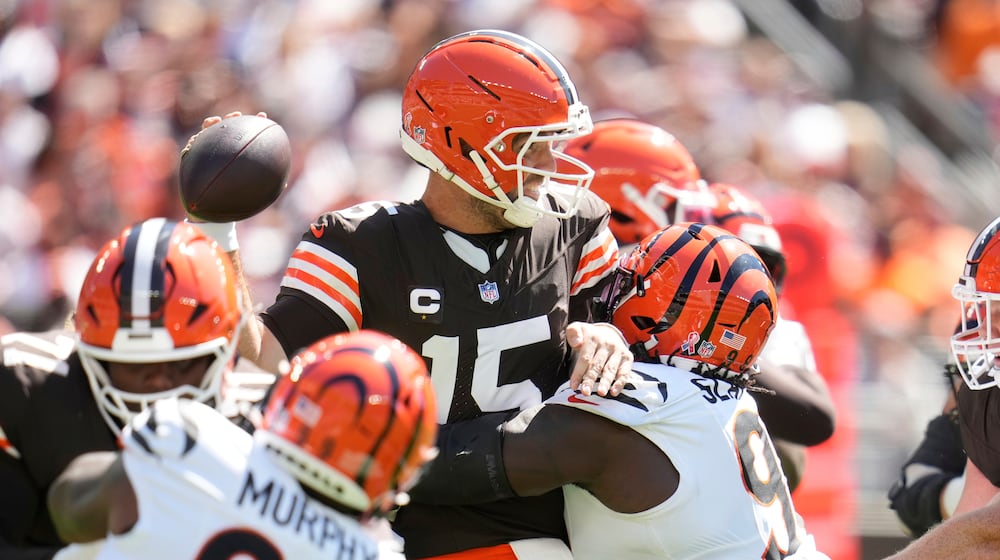 Cleveland Browns quarterback Joe Flacco throws under pressure from Cincinnati Bengals defensive tackle T.J. Slaton Jr. during the first half of an NFL football game Sunday, Sept. 7, 2025, in Cleveland. (AP Photo/Sue Ogrocki)