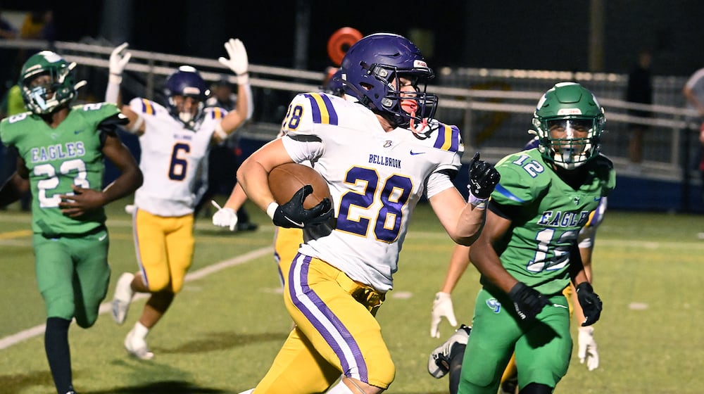 Bellbrook High School freshman Bryce Elmeier runs past Chaminade Julienne sophomore Kayden Greene-Paschal during their 41-0 over the Eagles on Friday night at Roger Glass Stadium in Dayton. NICK FALZERANO/CONTRIBUTED PHOTO