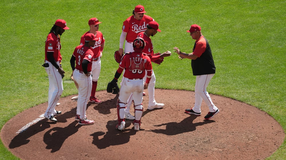 Cincinnati Reds' manager Terry Francona, right, pulls Hunter Greene, center, in the seventh inning of a baseball game against the Toronto Blue Jays, Monday, Sept. 1, 2025, in Cincinnati. (AP Photo/Kareem Elgazzar)