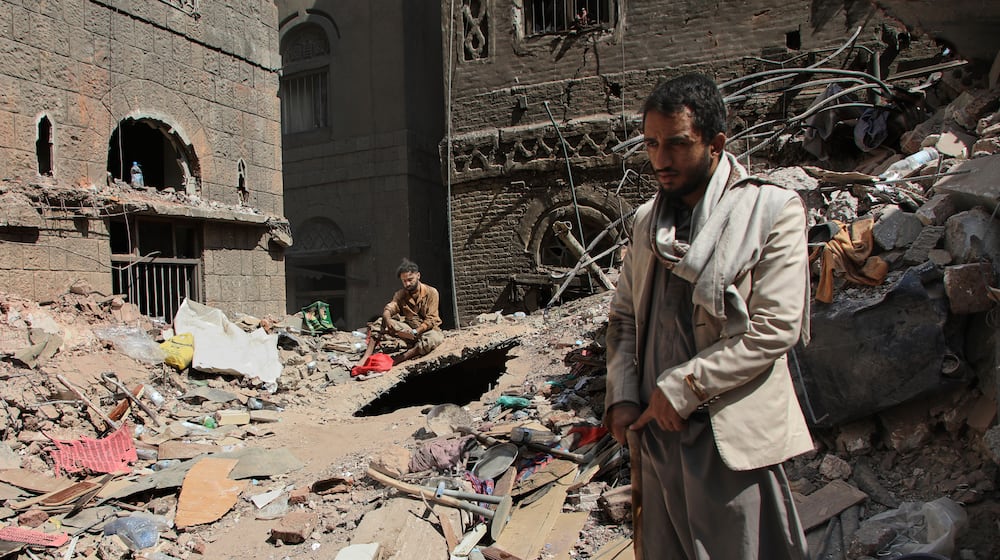Two Yemeni men inspect the rubble of a house that was destroyed in Wednesday's Israeli airstrikes, in Sanaa, Yemen, Saturday, Sept. 13, 2025. (AP Photo/Osamah Abdulrahman)