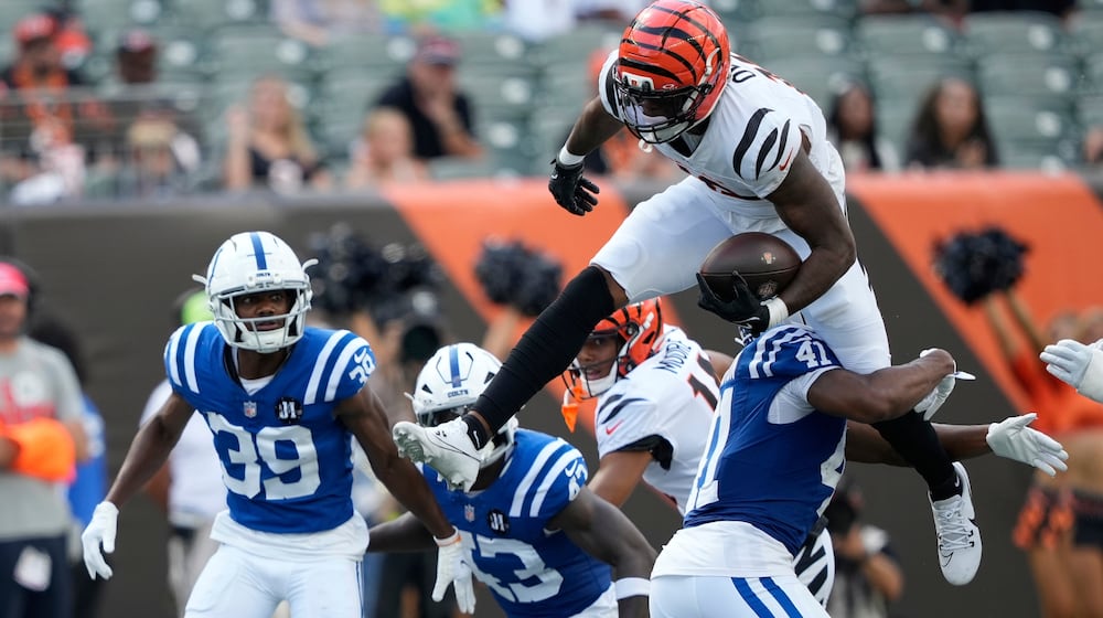 Cincinnati Bengals' Rashod Owens (12) leaps against Indianapolis Colts safety Trey Washington (41)during the second half of a preseason NFL football game, Saturday, Aug. 23, 2025, in Cincinnati. (AP Photo/Carolyn Kaster)