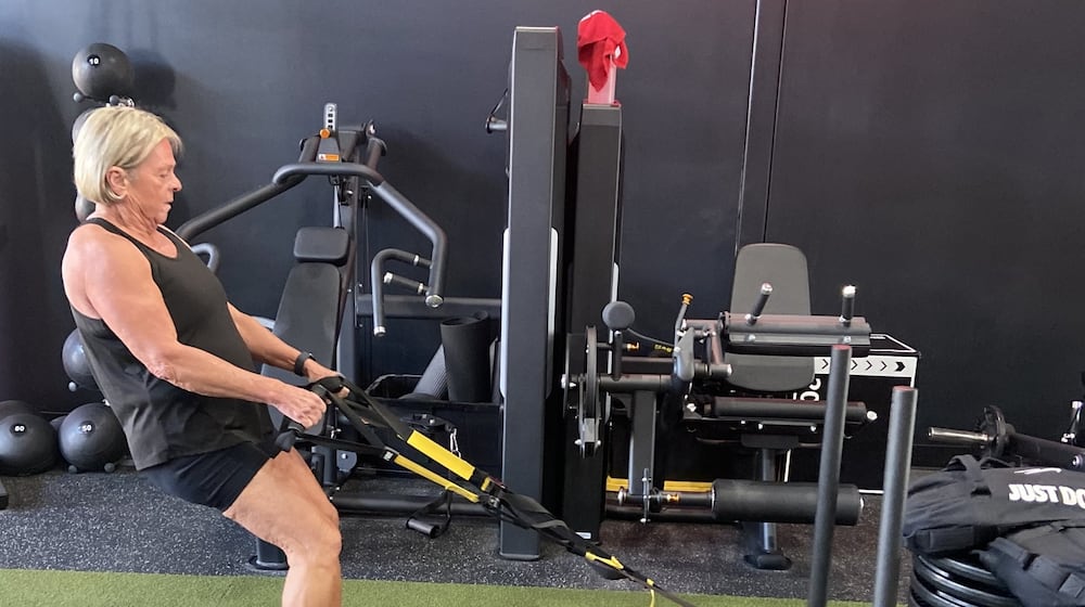 Marcy Schade pulls a weight sled stacked with 525 pounds across the fitness room floor. CONTRIBUTED
